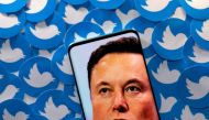 An image of Elon Musk is seen on a smartphone placed on printed Twitter logos in this picture illustration taken April 28, 2022. File Photo / Reuters