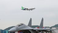 Chinese passenger jet C919 performs near a fighter jet of the Chinese People's Liberation Army (PLA) Air Force, at the China International Aviation and Aerospace Exhibition, or Airshow China, in Zhuhai, Guangdong province, China November 8, 2022. (China Daily via REUTERS) 