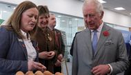 Britain's King Charles looks at eggs as he meets staff and suppliers at Morrisons Supermarkets headquarters during a two-day tour of Yorkshire in Bradford, Britain November 8, 2022. Reuters/Russell Cheyne/Pool