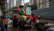 People buy vegetables in a street market at the Jose Felix Ribas community in the Petare neighborhood in Caracas, Venezuela, on November 5, 2022. (Photo by Federico PARRA / AFP)