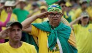 People make a military gesture during a protest held by supporters of Brazil's President Jair Bolsonaro against President-elect Luiz Inacio Lula da Silva who won a third term following the presidential election run-off, at the Army Headquarters in Brasilia, Brazil, on November 7, 2022. REUTERS/Ueslei Marcelino/File Photo