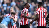 Brentford's English striker Ivan Toney (centre) celebrates with Brentford's English-born Jamaican defender Ethan Pinnock (right) on the pitch after the English Premier League football match between Manchester City and Brentford at the Etihad Stadium in Manchester, north west England, on November 12, 2022. - Brentford won the game 2-1. (Photo by Oli SCARFF / AFP) 