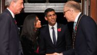 Britain's Prime Minister Rishi Sunak (second right) and his wife Akshata Murthy (second left) arrive to attend the annual Royal British Legion Festival of Remembrance at the Royal Albert Hall in London on November 12, 2022. (Photo by CHRIS RADBURN / POOL / AFP)