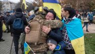 Local residents hug a Ukrainian soldier as they celebrate the liberation of Kherson, on November 13, 2022. (AFP)