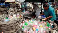 People sort through plastic bottles they collected and are about to sell at a junk shop in Manila March 10, 2015. REUTERS/Romeo Ranoco/File Photo