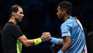 Spain's Rafael Nadal (left) and Canada's Felix Auger-Aliassime tap hands after Auger-Aliassime won their round-robin match on November 15, 2022 at the ATP Finals tennis tournament in Turin. (Photo by Marco BERTORELLO / AFP)