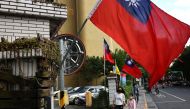 People walk by Taiwanese flags in Taipei, Taiwan, November 14, 2022. (REUTERS/Ann Wang)