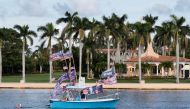 Supporters sail their boat in Lake Worth Lagoon behind former US President Donald Trump's Mar-a-Lago estate where he says he will make a 
