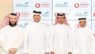 Vodafone Qatar and  Mowasalat officials exchange the agreement at the launch.