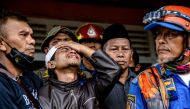 Ahmad Ashikin (2L), father of seven-year-old Indonesian girl Ashika Nur Fauziah, reacts after rescue personnels found her dead under the rubble at Cugenang village, in Cianjur, on November 25, 2022. Photo by Mas Agung Wilis / AFP