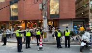 Police officers stand next to a cordon line set up near the site where a protest against COVID-19 curbs took place. Reuters/David Stanway