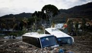 Damaged buses lie amongst debris following a landslide on the Italian holiday island of Ischia, Italy, November 27, 2022. (REUTERS/Guglielmo Mangiapane)