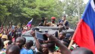 Burkina Faso's self-declared new leader Ibrahim Traore is welcomed by supporters holding Russian's flags as he arrives at the national television standing in an armoured vehicle in Ouagadougou, Burkina Faso, on October 2, 2022. File Photo / Reuters
