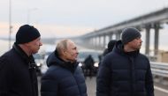 Russian President Vladimir Putin, flanked by Deputy Prime Minister Marat Khusnullin (left), visits the Kerch Strait Bridge, also known as the Crimean Bridge on December 5, 2022. The bridge, that links Russia's mainland with the Crimean Peninsula, was damaged by an attack on October 8, 2022. (Photo by Mikhail Metzel / SPUTNIK / AFP) / 