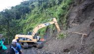 Rescue teams use heavy equipment to remove soil after a mountain landslide in the sector El Ruso, Pueblo Rico municipality, in northwestern Bogota, Colombia, on December 5, 2022. (Photo by STRINGER / AFP)