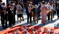 People watch Sony's robotic dogs 'Aibo' during a ritual ceremony Sichi-Go-San, which is usually held for praying for children's health and wellbeing, at the Kanda Myojin shrine in Tokyo, Japan, November 11, 2022. REUTERS/Kim Kyung-Hoon/File Photo