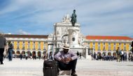 A tourist rests at Comercio square in downtown Lisbon, Portugal, April 11, 2019. (REUTERS/Rafael Marchante)