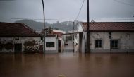 A hose is pictured in the middle of a flooded street, in Frielas, on the outskirts of Lisbon, following heavy rain on December 13, 2022. (Photo by CARLOS COSTA / AFP)
