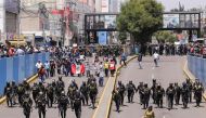 Police officers walk beside protesters taking part in a march demanding the dissolution of the Congress and to hold democratic elections rather than recognising Dina Boluarte as Peru's President, after the ouster of Peruvian leader Pedro Castillo in Arequipa, Peru, December 14, 2022. (REUTERS/Oswald Charca)