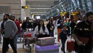 Travellers push carts with their luggage at the departure area of Terminal 3 at Indira Gandhi International Airport in New Delhi, India, December 14, 2022. REUTERS/Anushree Fadnavis