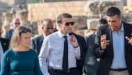French President Emmanuel Macron (centre) visits the archaeological site of Jerash, Jordan on December 21, 2022.  (Photo by Eliot BLONDET / POOL / AFP)