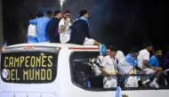 Argentina's Rodrigo De Paul, Leandro Paredes, Lionel Messi and Julian Alvarez are seen on the open top bus as it arrives outside the Association of Argentinian Football Headquarters in Buenos Aires, Argentina, on December 20, 2022. (REUTERS/Mariana Nedelcu)