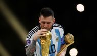 Argentina's Lionel Messi kisses the World Cup trophy after receiving the Golden Ball award as he celebrates after winning the FIFA World Cup in Qatar on December 18, 2022. (REUTERS/Kai Pfaffenbach)
