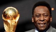 In this file photo taken on March 09, 2014, Brazilian football legend Pele poses with the FIFA World Cup trophy during a press conference, outside the Hotel de Ville in Paris. (Photo by Franck Fife / AFP)