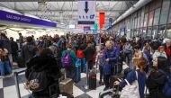 Travelers arrive for their flights at the United Airlines Terminal 1 ahead of the Christmas Holiday, at O'Hare International Airport on December 22, 2022, in Chicago. (Photo by Kamil Krzaczynski / AFP)
