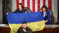 Ukraine's President Volodymyr Zelensky speaks after giving a Ukrainian national flag to US House Speaker Nancy Pelosi and US Vice President Kamala Harris (left) during his address to the US Congress at the US Capitol in Washington, DC on December 21, 2022. (Photo by Mandel Ngan / AFP)

