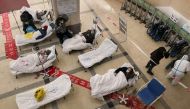 Covid-19 patients lie on hospital beds in the lobby of the Chongqing No. 5 People's Hospital in China's southwestern city of Chongqing on December 23, 2022. (Photo by Noel Celis / AFP)