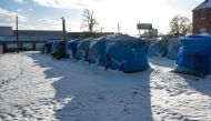 A row of tents is seen at The Hope Village, a secure tent encampment established for homeless people, on December 24, 2022 in Louisville, Kentucky. Heavy winter precipitation and temperatures 40 degrees below average are expected throughout the Christmas weekend over much of the United States. Jon Cherry/Getty Images/AFP