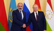 Russian President Vladimir Putin (R) greets Armenian Prime Minister Nikol Pashinyan ahead of an informal meeting of the heads of state of the Commonwealth of Independent States (CIS) at the Boris Yeltsin Presidential Library in Saint Petersburg on December 26, 2022. (Photo by Alexey DANICHEV / SPUTNIK / AFP)