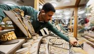 A gold vendor sorts jewellery pieces inside a shop at the gold market area, as gold prices recorded an increase after the latest devaluation of the local currency in Cairo, Egypt, December 8, 2022. (REUTERS/Mohamed Abd El Ghany)
