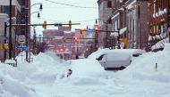 In this handout photo from the Office of Governor Kathy Hochul, vehicles are seen trapped under heavy snow in the streets of downtown Buffalo, New York, on December 26, 2022. (Photo by THE OFFICE OF GOVERNOR KATHY HOCHUL / AFP) 