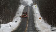 A snow plow travels down a stretch of open highway, working on the side roads following a deadly Christmas blizzard, in Elma, New York, US, December 27, 2022. (REUTERS/Robert Kirkham)
