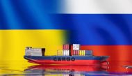 A cargo ship boat model is pictured in front of Ukraine's and Russian's flags in this illustration taken on March 3, 2022. File Photo / Reuters