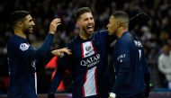 Paris Saint-Germain's French forward Kylian Mbappe (R) celebrates after scoring a penalty with Paris Saint-Germain's Moroccan defender Achraf Hakimi (L) and Paris Saint-Germain's Spanish defender Sergio Ramos in Paris on December 28, 2022. (Photo by Julien De Rosa / AFP)