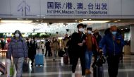 Travellers walk with their luggage at Beijing Capital International Airport, amid the coronavirus disease (COVID-19) outbreak in Beijing, China December 27, 2022. REUTERS/Tingshu Wang/File Photo
