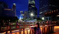 People wearing protective masks enjoy a pedestrian bridge during the dusk amid of the coronavirus disease (COVID-19) pandemic in Jakarta, Indonesia, March 15, 2022. REUTERS/Willy Kurniawan

