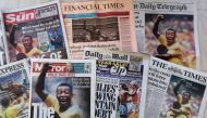 An arrangement of UK daily newspaper front pages photographed as an illustration in London on December 30, 2022, shows headlines reporting on the death of Brazilian football legend Pele, who died on December 29, 2022. Photo by ISABEL INFANTES / AFP)