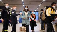 Passengers of a flight from China wait in a line for checking their COVID-19 vaccination documents as a preventive measure against the Covid-19 coronavirus, after arriving at the Paris-Charles-de-Gaulle airport in Roissy, outside Paris, on January 1, 2023. (Photo by JULIEN DE ROSA / AFP)