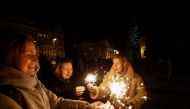 Women hold bengal fires during a celebration of New Year eve before a curfew, amid Russia's attack on Ukraine, in front of the St. Sophia Cathedral in Kyiv, Ukraine, December 31, 2022. (REUTERS/Valentyn Ogirenko)