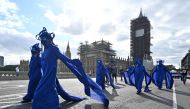 In this file photo taken on September 6, 2020 Activists from the climate change group Extinction Rebellion lead a procession across Westminster Bridge in central London. (Photo by JUSTIN TALLIS / AFP)