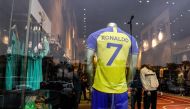 The full set football uniform for Saudi club al-Nasr's new Portuguese forward Cristiano Ronaldo (#7) is displayed at a sports shop carrying the club's paraphernalia in the capital Riyadh on January 2, 2023.  (Photo by Fayez Nureldine / AFP)