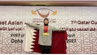 A Qatari weightlifter poses with her medals.