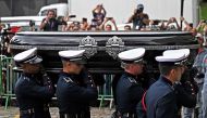 The coffin of the late Brazilian football star Pele is transported to the Santos' Memorial Cemetery after the funeral procession in Santos, Sao Paulo state, Brazil on January 3, 2023. (Photo by CARL DE SOUZA / AFP)