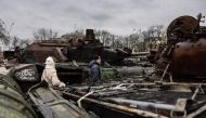 Pedestrians look at the destroyed Russian military vehicles at an open air exhibition of destroyed Russian equipment in Kyiv on January 5, 2023. (Photo by Sameer Al-Doumy / AFP)