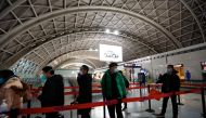 Travellers queue to board a plane at Chengdu Shuangliu International Airport amid a wave of the coronavirus disease (COVID-19) infections, in Chengdu, Sichuan province, China, December 30, 2022. (REUTERS/Tingshu Wang)