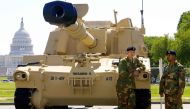 In this file photo taken on May 10, 2002, SSGT Brian Jones and SPC Bill Sharp stand by their M109A6 Paladin Self Propelled Howitzer tank in Washington, DC. (Photo by Paul J Richards / AFP)